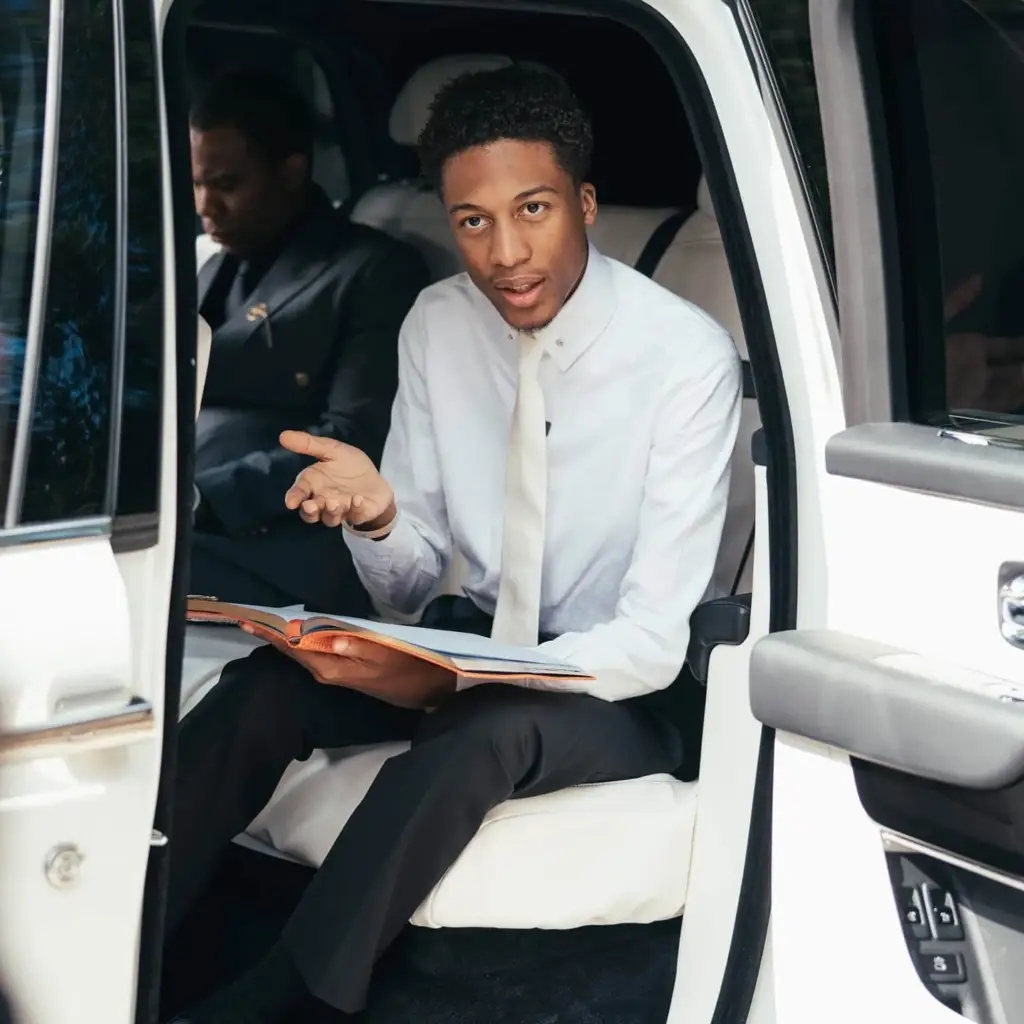 Uebert Angel Jr. seated in a car